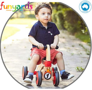 Ride on four wheeled wooden push bike on rubber wheels for toddlers.