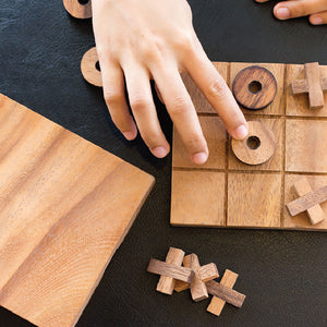 TIC TAC TOE naughts and Crosses board game on a wooden platform