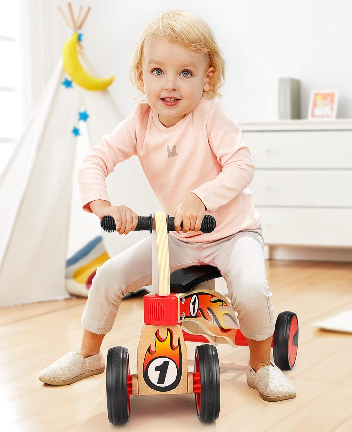 Ride on four wheeled wooden push bike on rubber wheels for toddlers.