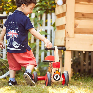 Ride on four wheeled wooden push bike on rubber wheels for toddlers.