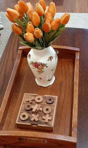 TIC TAC TOE naughts and Crosses board game on a wooden platform